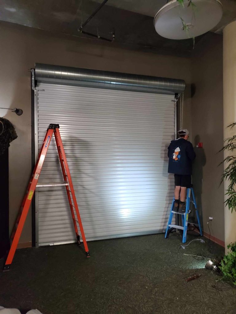 Two Trinity techs on a ladder